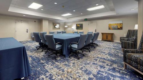 a conference room with a blue table and chairs at Hampton Inn St. Simons Island in Saint Simons Island