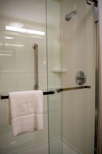 a shower with a glass door and a towel at Hampton Inn St. Louis-Chesterfield in Chesterfield