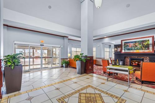 a lobby with a fireplace in a building at Hilton Garden Inn Starkville in Starkville