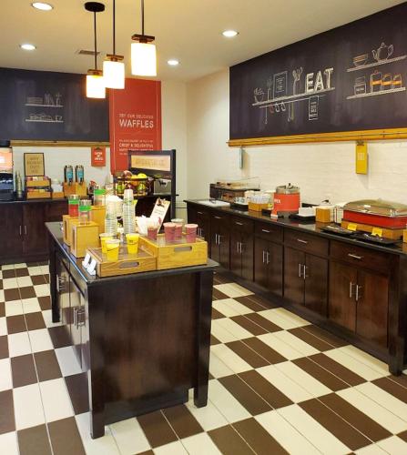 a fast food restaurant with a counter with food at Hampton Inn Stow in Stow