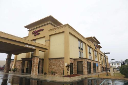 a store front of a hotel with a sign on it at Hampton Inn Sumter in Sumter