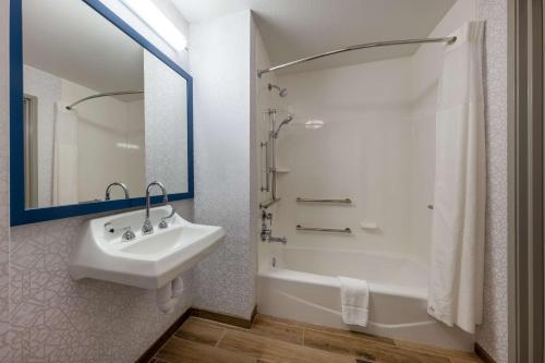a white bathroom with a sink and a shower at Hampton Inn Saint Robert in Saint Robert