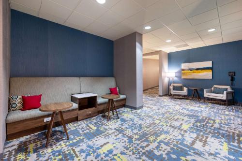a waiting room with a couch and two tables at Hampton Inn Saint Robert in Saint Robert
