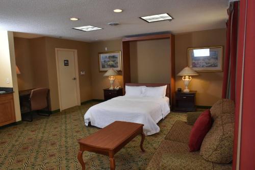 a hotel room with a bed and a couch at Hampton Inn Stony Creek in Stony Creek