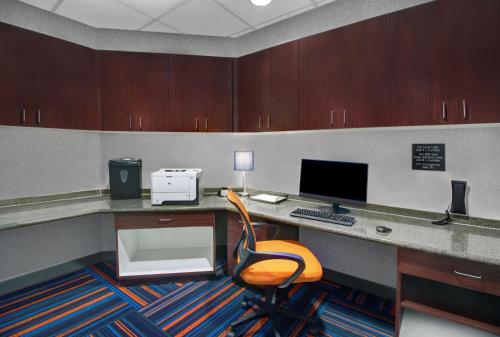 an office with a desk with a computer and a chair at Hampton Inn & Suites by Hilton Syracuse Dewitt in East Syracuse