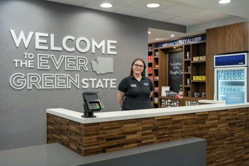 a woman standing behind a counter in a store at Hampton Inn & Suites Tacoma/Puyallup in Puyallup