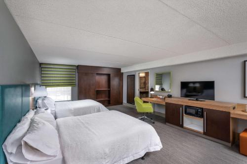 a hospital room with a bed and a television at Hampton Inn Tuscaloosa - East in Tuscaloosa