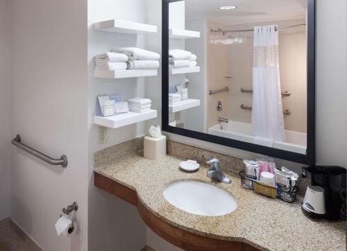 a bathroom with a sink and a mirror at Hampton Inn & Suites Tulare in Tulare