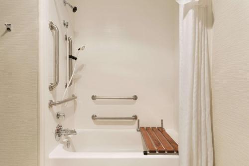 a bathroom with a shower and a toilet in it at Homewood Suites by Hilton Toledo-Maumee in Maumee