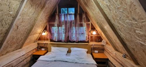 a room with a bed and two pillows at Altana letnia nr2 - Herbergerówka Agroturystyka na wsi in Stosrow