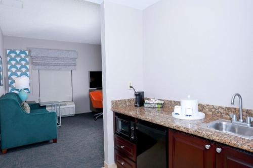 a kitchen with a sink and a counter top at Hampton Inn & Suites Tampa-Wesley Chapel in Wesley Chapel