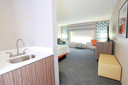 a bathroom with a sink and a room with a bed at Hampton Inn & Suites Tampa-Wesley Chapel in Wesley Chapel