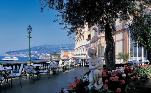 a statue of a woman sitting next to a tree at Grand Hotel Excelsior Vittoria in Sorrento