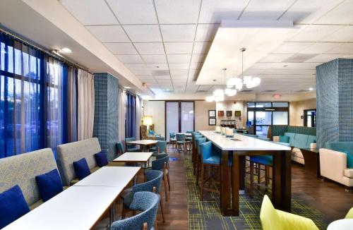 a waiting room with tables and chairs in a hospital at Hampton Inn Tucson-Airport in Tucson