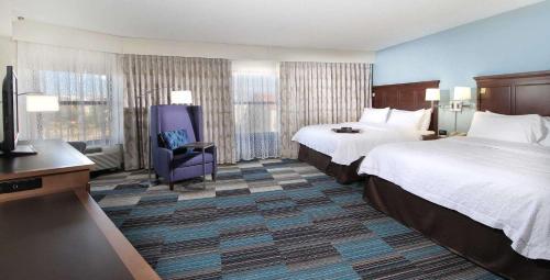 a hotel room with two beds and a television at Hampton Inn Tucson-Airport in Tucson