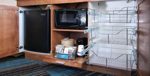 a kitchen with a microwave and a tv on a cabinet at Hampton Inn Tucson-Airport in Tucson