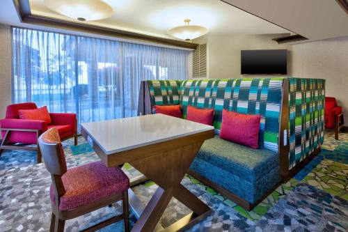 a waiting room with colorful chairs and a table at Hampton Inn Traverse City in Traverse City