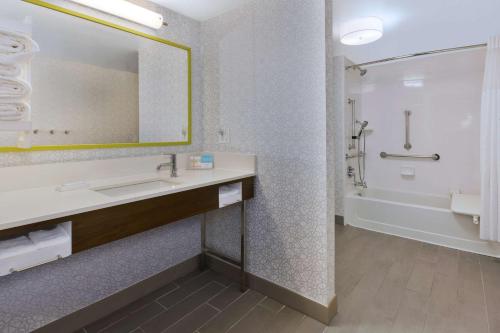 a bathroom with a sink and a mirror at Hampton Inn Traverse City in Traverse City