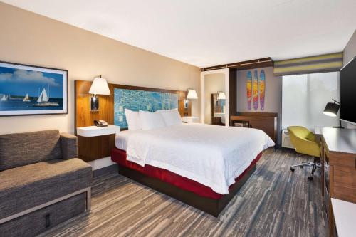 a hotel room with a bed and a desk at Hampton Inn Traverse City in Traverse City