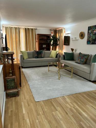 a living room with a couch and a table at Bayswater Apartments in London