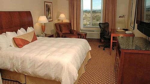 a hotel room with a bed and a desk at Hilton Garden Inn Victorville in Victorville