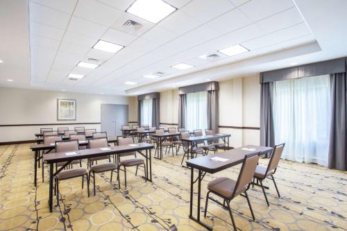 a classroom with tables and chairs in a room with windows at Hampton Inn Philadelphia/Voorhees in Voorhees