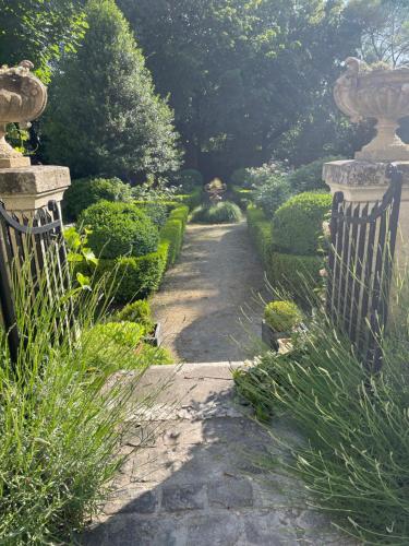 a garden with a stone gate and a walkway at Belle Fontaine in Bourges