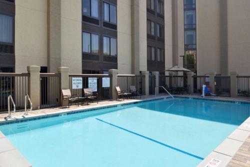 a large blue swimming pool in front of a building at Hampton Inn Los Angeles-West Covina in West Covina