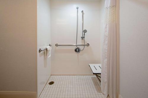 a bathroom with a shower with a tiled floor at Hampton Inn Los Angeles-West Covina in West Covina