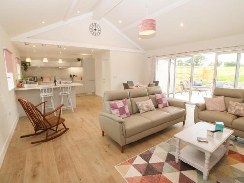 a living room with a couch and a table at Y Beudy in Caernarfon