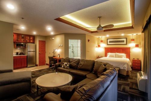 a living room with a couch and a bed at Hampton Inn Wheeling in Wheeling