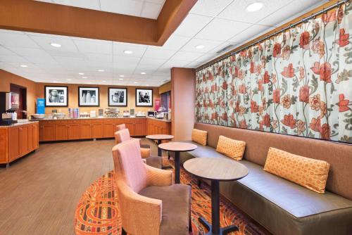 a waiting room at a hospital with tables and chairs at Hampton Inn Winfield Teays Valley in Teays Valley Estates