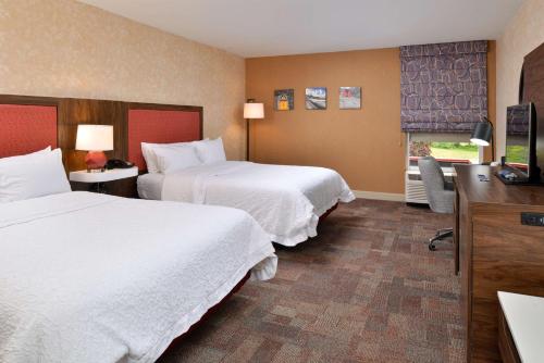 a hotel room with two beds and a television at Hampton Inn Wytheville in Wytheville