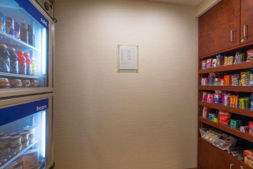 a refrigerator door in a store with food inside at Hampton Inn White River Junction in White River Junction