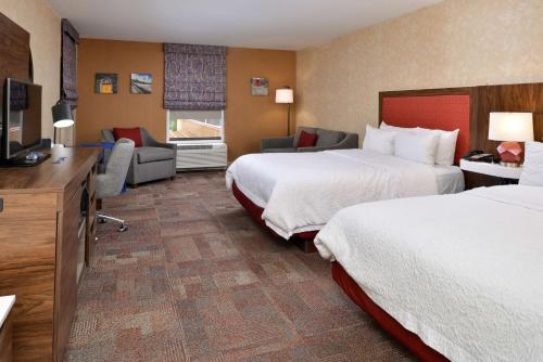 a hotel room with two beds and a television at Hampton Inn Wytheville in Wytheville