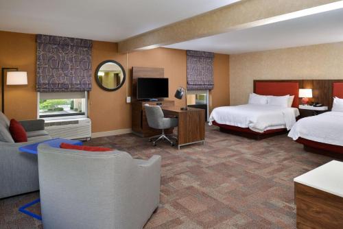 a hotel room with two beds and a desk at Hampton Inn Wytheville in Wytheville