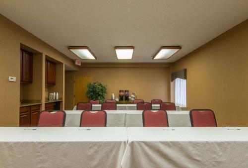 a conference room with a long table and red chairs at Hampton Inn White River Junction in White River Junction