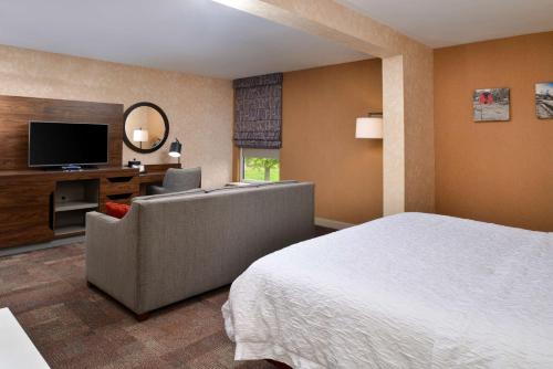 a hotel room with a bed and a television at Hampton Inn Wytheville in Wytheville