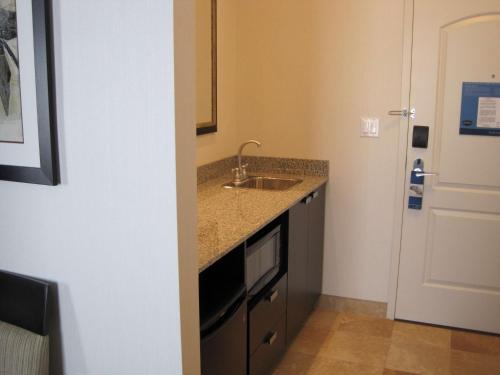 a small kitchen with a sink and a microwave at Hampton Inn by Hilton Fort Saskatchewan in Fort Saskatchewan