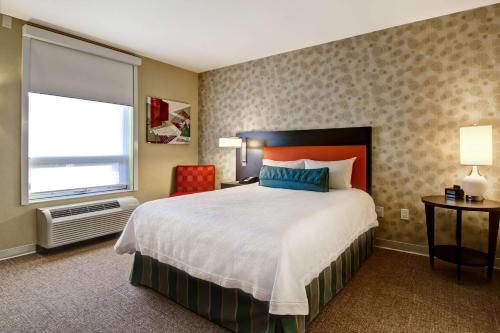 a bedroom with a large bed and a window at Home2 Suites by Hilton West Edmonton in Edmonton