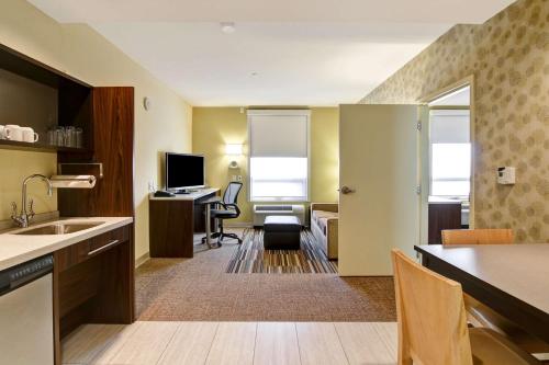 a room with a kitchen and a living room at Home2 Suites by Hilton West Edmonton in Edmonton