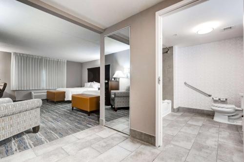 a hotel room with a bed and a bathroom at Hampton Inn & Suites by Hilton Brantford in Brantford