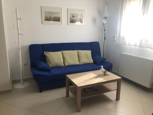 a blue couch in a living room with a coffee table at Artemis House in Artemida