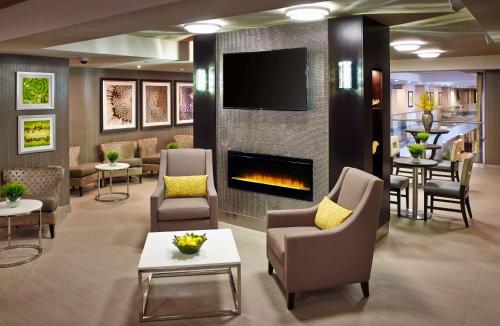 a lobby with a waiting room with a fireplace at Homewood Suites by Hilton Hamilton in Hamilton