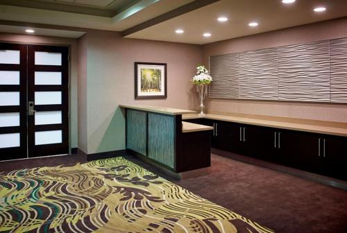 a lobby with a desk and a door and a carpet at Homewood Suites by Hilton Hamilton in Hamilton
