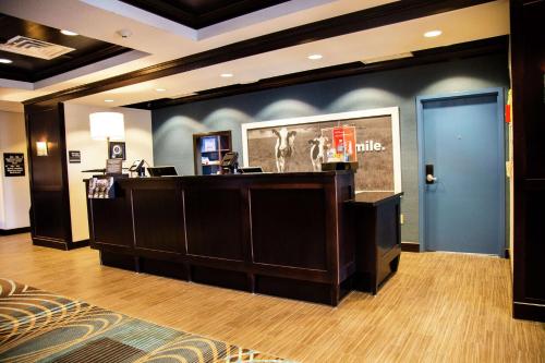 a lobby of a hotel with a reception desk at Hampton Inn & Suites Sharon in West Middlesex