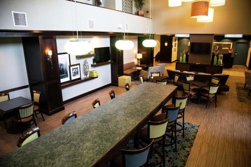 eine Bar in einem Restaurant mit Stühlen und Tischen in der Unterkunft Hampton Inn & Suites Sharon in West Middlesex