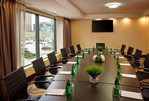 a conference room with a long table with bottles on it at Homewood Suites by Hilton Hamilton in Hamilton