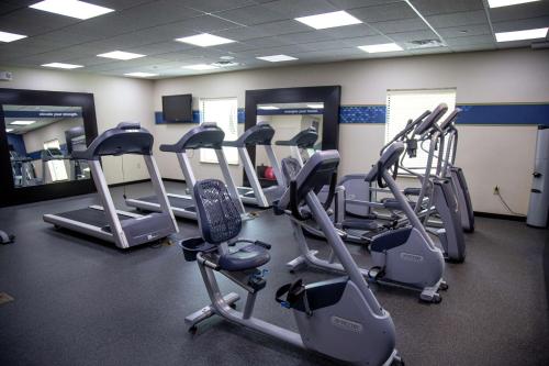a gym with a bunch of treadms and elliptical machines at Hampton Inn & Suites Sharon in West Middlesex