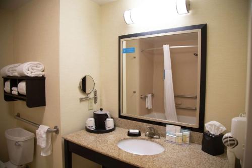 a bathroom with a sink and a large mirror at Hampton Inn & Suites Sharon in West Middlesex